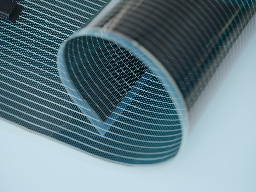 ST-OPV film-type solar cell rolled into a cylindrical shape, demonstrating its flexibility and bendability